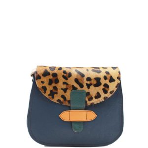 Handcrafted crossbody shoulder bag made from 100% recycled leather with reversible flap in pink, dark blue, and animal print tones, featuring dual zip compartments and adjustable leather strap, eco-friendly saddle bag for women