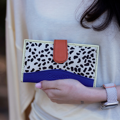 Women’s recycled leather wallet in blue and orange tones with animal print and multiple card compartments